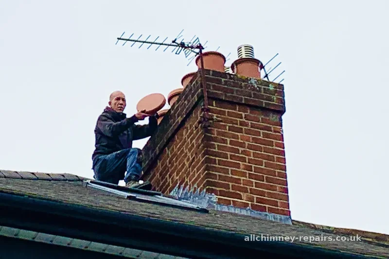 Chimney repair specialist — C-Cap vented cap being installed to chimney pot, prevents bird entry into flue and reduces heat loss from unused fireplaces, Romford | Allchimney Repairs