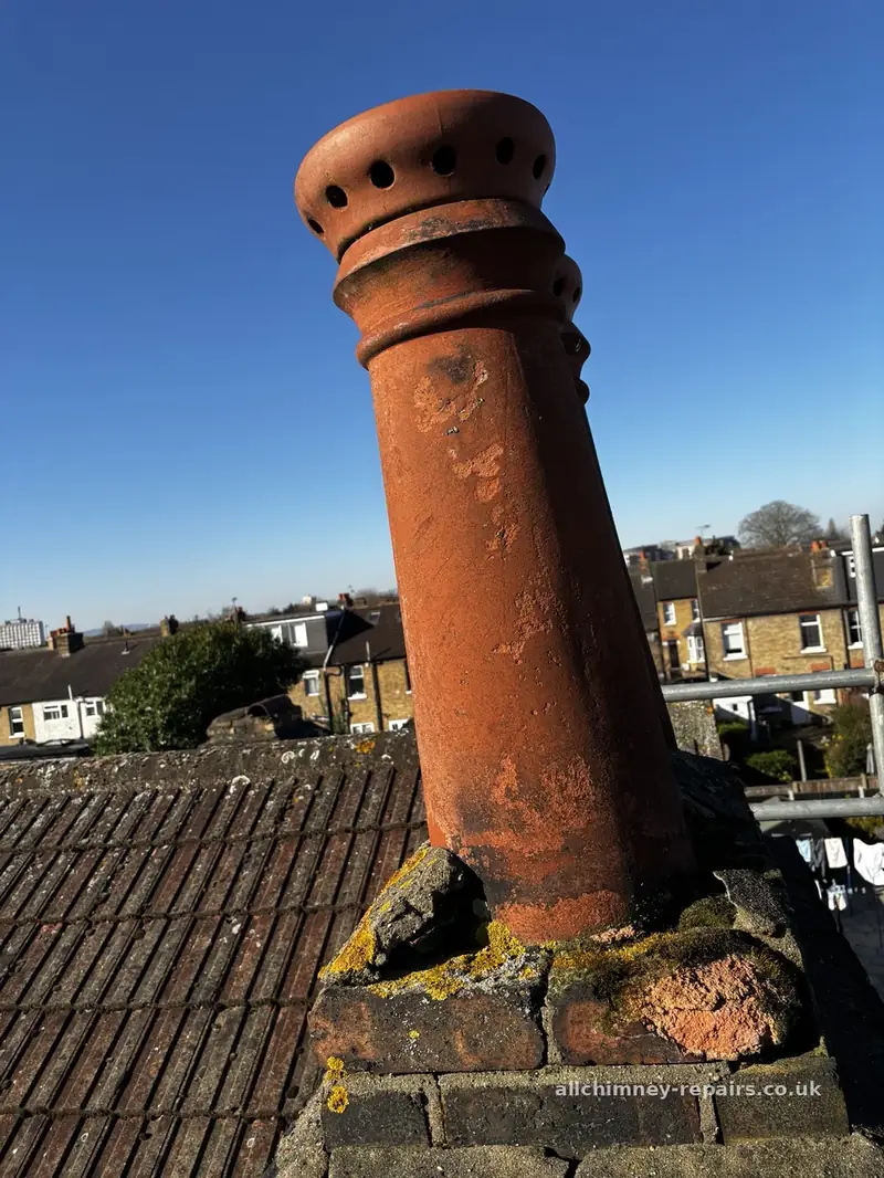 Chimney repair specialist — dangerous leaning chimney pot with missing flaunching, pot removed to ground, chimney inspected, brick repairs carried out and pot reseated, Romford | Allchimney Repairs