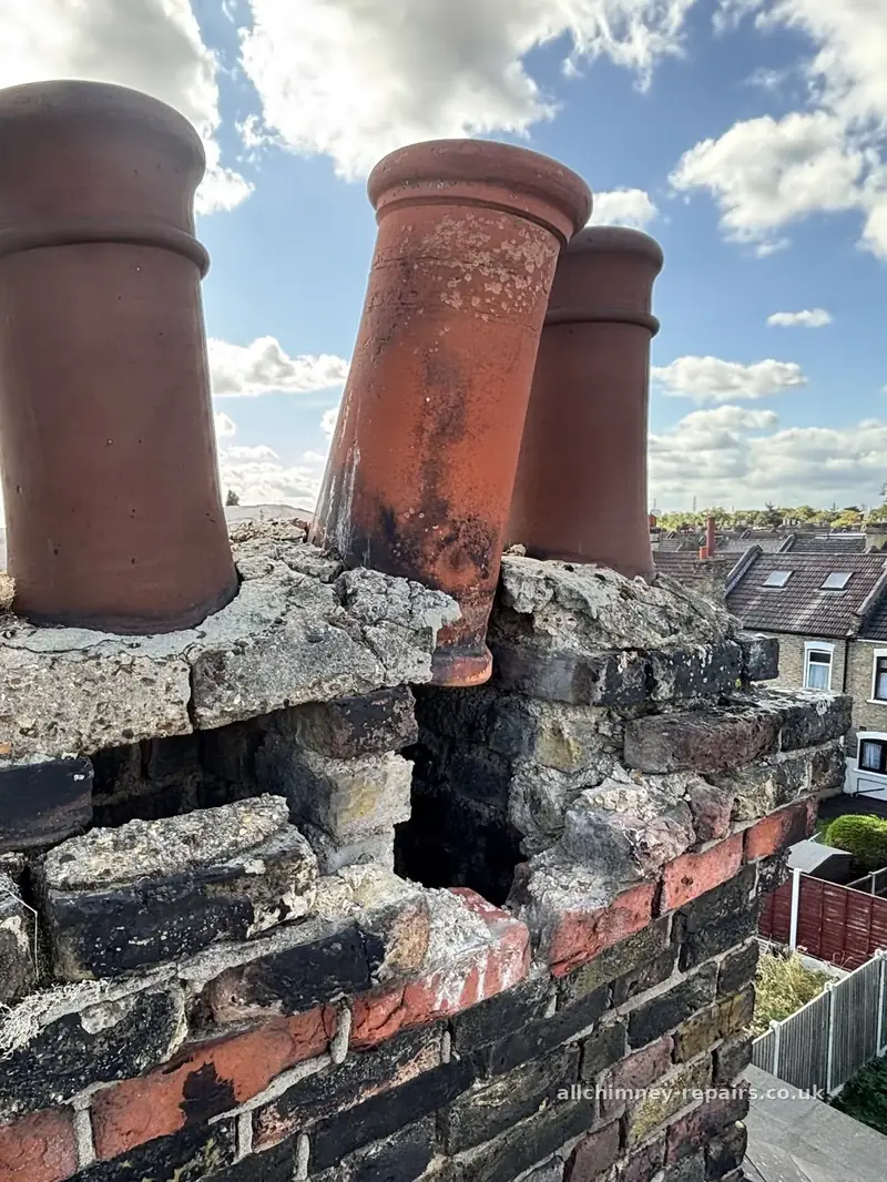 Chimney repair specialist — collapsed corbelled chimney head, 1920s London stock stack with original oversized terracotta pots, failed lime mortar joints, Rise Park Romford | Allchimney Repairs