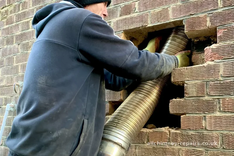 Chimney repair specialist — damaged flexible liner removed via carefully hand-cut external wall opening, brickwork reinstated after loft extension works damaged the original liner, Harold Wood | Allchimney Repairs