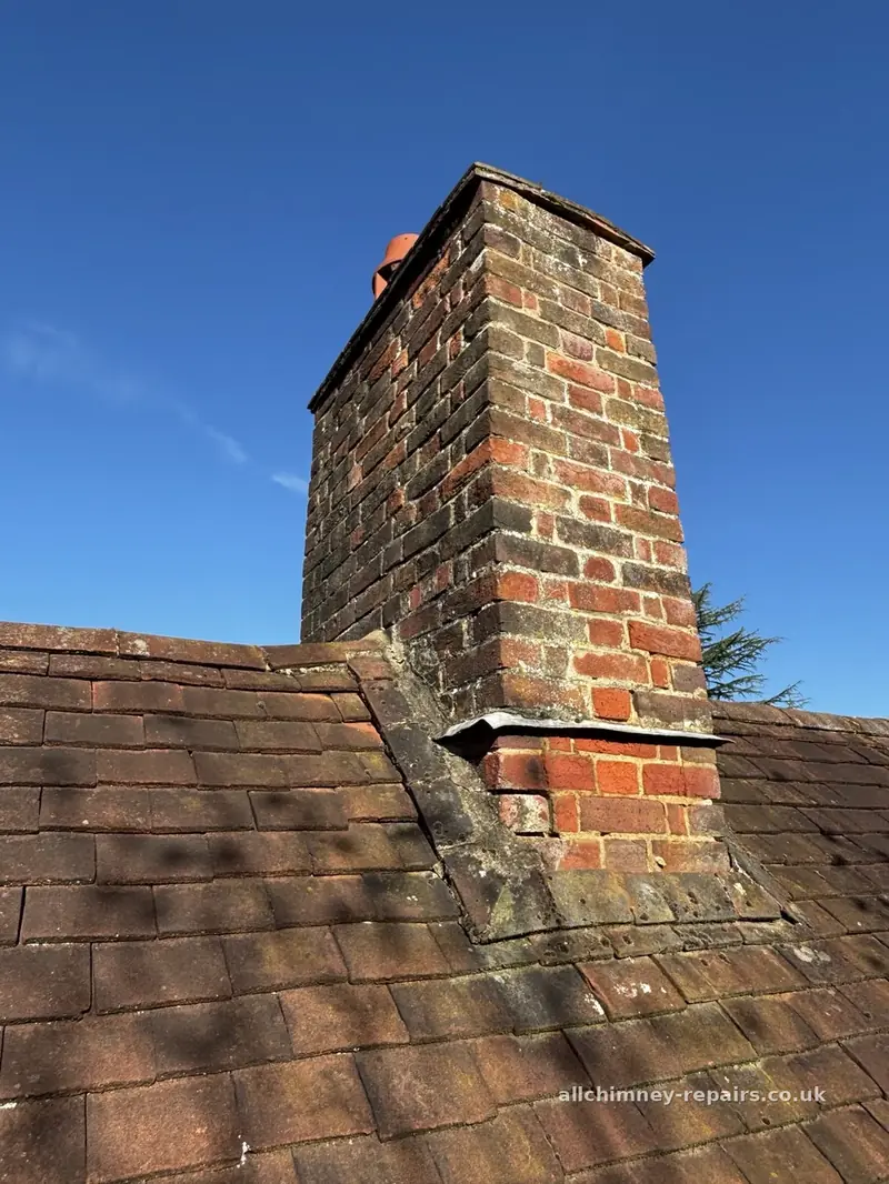 Chimney repair specialist — chimney repointing before works, creasing tiles under flaunching, lead damp course and original cement and tile fillet at roof junction, Harold Hill | Allchimney Repairs