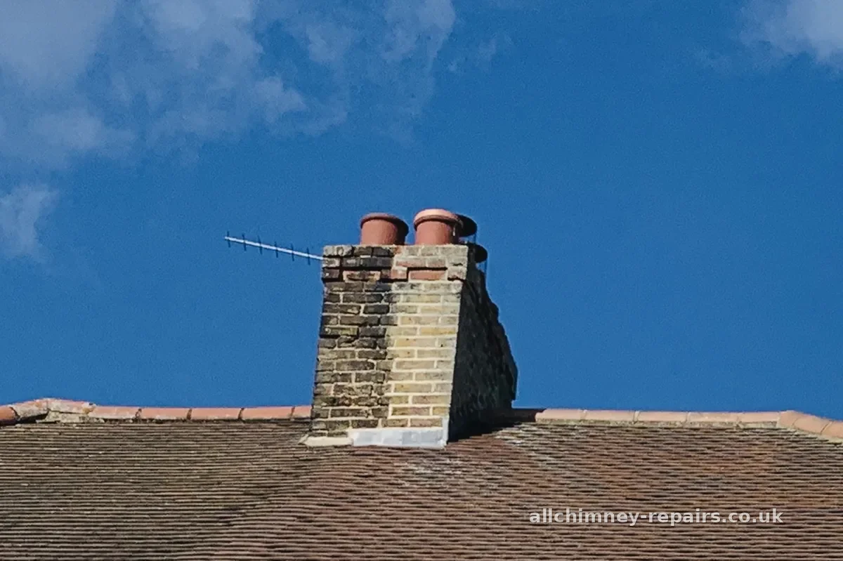 Chimney repair specialist — chimney brickwork moss cleaned, mortar raked out and repointed on shared chimney stack, Romford | Allchimney Repairs