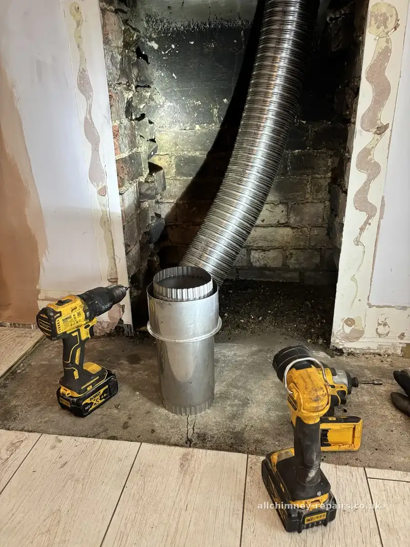HETAS registered chimney lining — 125mm multifuel flexible liner with flex adaptor at builders opening, constructional hearth visible, Gidea Park Romford | Allchimney Repairs