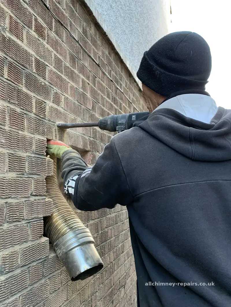HETAS registered chimney lining — damaged flexible liner removed via hand-cut external wall opening, brickwork reinstated to near-invisible finish, loft extension liner damage repaired, Romford | Allchimney Repairs